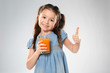 © Africa Studio - Cute little girl with glass of juice on light background
