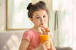 © Africa Studio - Cute little girl drinking juice at home