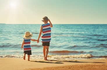 Two brothers are walking on the beach