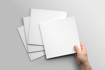 blank square photorealistic brochure mockup on light grey background.