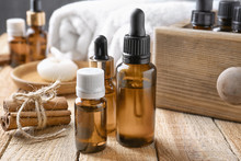 Composition With Bottles Of Cinnamon Oil On Wooden Background