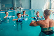 © Nomad_Soul - Women aqua aerobics traninig with dumbbells