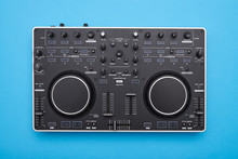 Modern DJ mixer on blue background