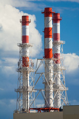 Industrial chimneys on a background of blue sky