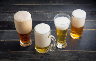 Beer glasses with various beer on old wood table