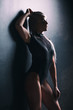 © Dewald - Sexy female fitness model in a studio with dramatic lighting and sexy outfit