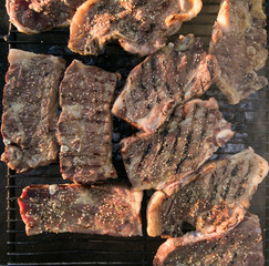 Wall Mural - Close up wide angle view of meat on the braai / barbeque as a traditional meal in south africa