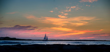 Sailboat Sailing Into Sunrise Sunset With Seagulls Flying