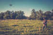 © scaliger - Man operating a drone quad copter