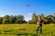© scaliger - Man operating drone quad copter in city park in summer