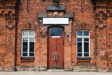Old Vintage Red Brick Wall Building. Wooden Door Entrance.
