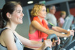© auremar - group of women riding on exercise bike in gym
