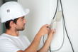 © auremar - electrician man worker installing a thermostat