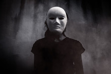 Mysterious Woman In Black Wearing White Mask Hidden Behind The Dark,Scary Background For Book Cover