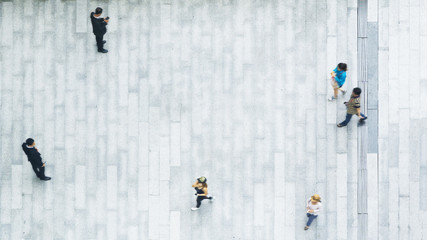 top view of business and tourist people group walk and stand on the white concrete pedestrian landscape.