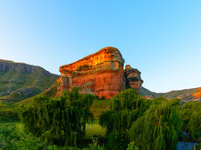 Scenic Panoramic South Africa Drakensberg Golden Gate National Park Landscape With An Impressive Golden Red Rock,mountains,trees, River  And A Sunny Blue Sky