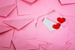 © Cozine - close up Stacking of pink envelopes and a  mail letter paper and red herat , romance  love letter concept for holiday valentines day greeting card concept