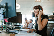 © Jacob Lund - Casual businesswoman working at her desk