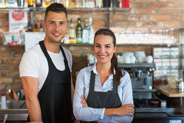 Wall Mural - Young man and woman working at cafe
