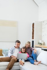 Wall Mural - Family using laptop together in living room