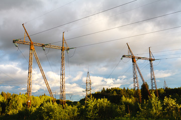 high-voltage power lines at sunset. electricity distribution station .