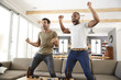 © Monkey Business - Two Excited Male Friends Celebrate Watching Sports On Television