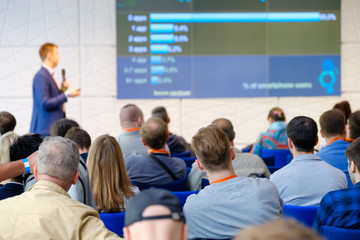 Audience listens to the lecturer at the conference hall