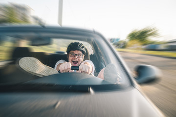 Wall Mural - man driving car in helmet with horror on her face