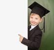 © Ermolaev Alexandr - Boy in graduation hat pointing at blank placard