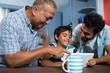 © WavebreakMediaMicro - Happy family using digital table