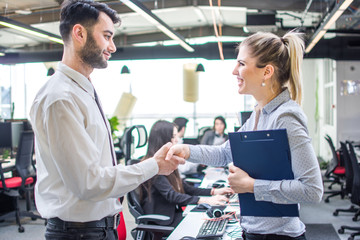 Wall Mural - Business people shaking hands, finishing a deal at the office.