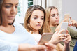 © highwaystarz - Group Of Teenage Girls Using Mobile Phones At Home
