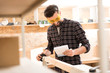 © Yakobchuk Olena - Positive woodworker is working with pleasure
