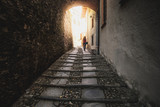 Fototapeta Uliczki - woman walk dark street narrow alley
