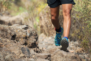 Wall Mural - Trail running man on mountain path exercising,workout outdoors on rocky terrain