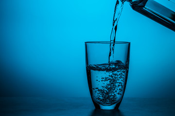 Wall Mural - Man pours water from glass