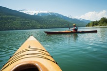 Cropped Image Of Kayak Against Man Kayaking In Lake