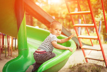 Happy Little Boy Climbing On Children Playground
