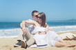 © Nuli_k - Young romantic couple sitting on the beach