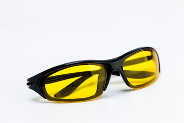 Sunglasses with yellow lenses on a white background