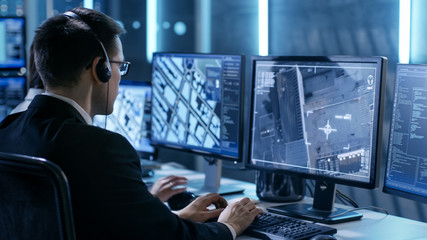 Aufkleber - Government Agent is Tracking Fugitive with Her Computer in Big Monitoring Room Full of Computers with Animated Screens.