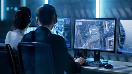 Aufkleber - Government Agent is Tracking Fugitive with Her Computer in Big Monitoring Room Full of Computers with Animated Screens.