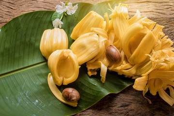 pieces of sweet ripe Jackfruit and seed laying on green banana leaf, Tropical fruit