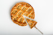© Vincent - Whole apple pie, top view, a piece is taken out with a chrome cake server