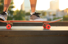 Young Woman Skateboarder Skateboarding At Sunrise City