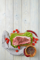 Wall Mural - raw meat with ingredients on a wooden background