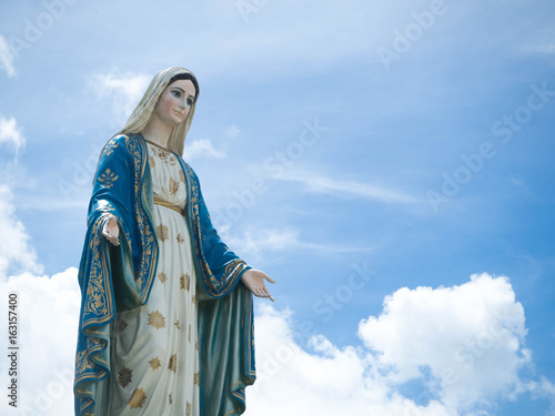 Fotografie, Obraz The Blessed Virgin Mary Statue blue sky background.