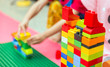 © nattanan - Preschooler child playing with colorful toy blocks. Preschool children build tower with plastic block. Toddler kid in nursery.