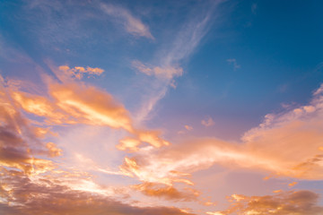 Wall Mural - sunset / sun rise sky with rays of yellow and red light shining clouds and sky background and textur