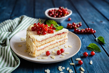 Wall Mural - Delicious cake with mascarpone, whipped cream, red currant and almond slices